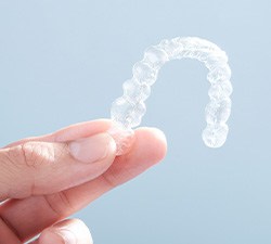 Patient holding clear aligner