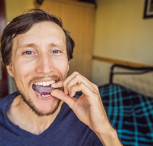 Patient putting in clear aligners 