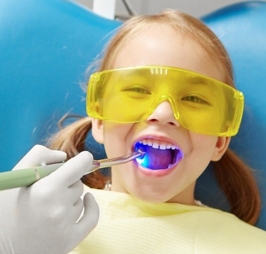 Child receiving dental sealants