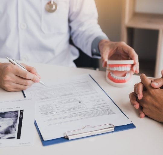 Dentist and patient discussing dental implant treatment plan