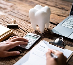 person calculating the cost of dentures in Gahanna