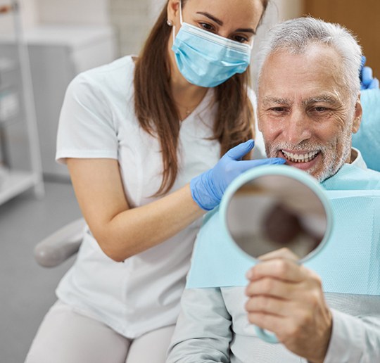 man smiling while visiting dentist 