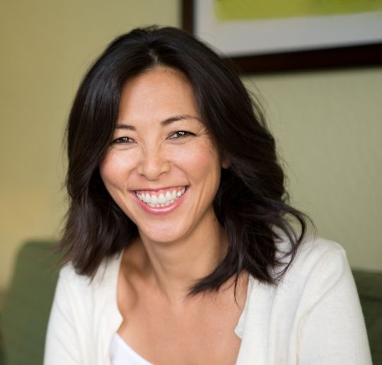 Woman smiling after dental implant restoration