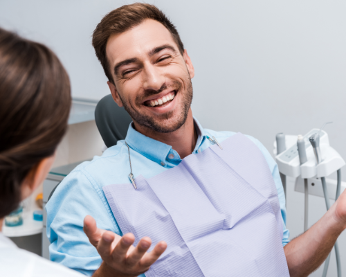 Man in dental chair laughing