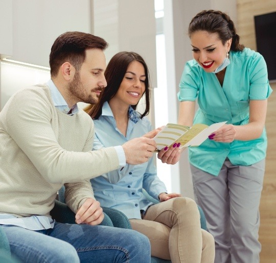 Dental patients looking at dental insurance forms