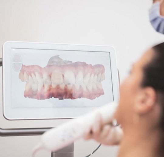 a dentist performing intraoral scanning on a patient