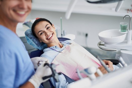 Patient smiling during dental checkup and cleaning