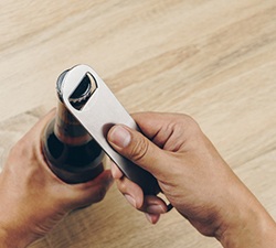 Patient using bottle cap opener