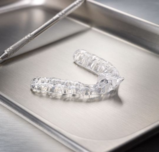 Clear nightguard for bruxism on metal tray