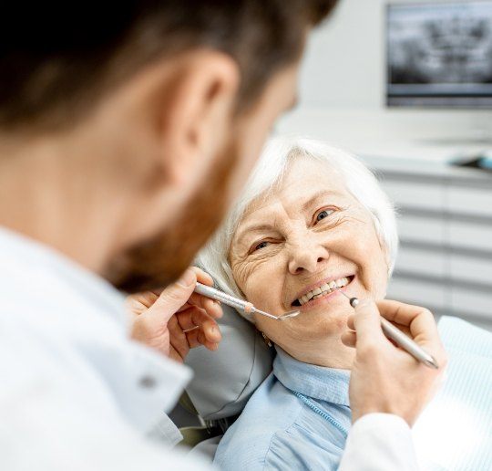 Woman receiving oral cancer screening