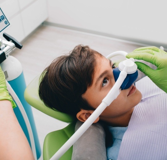 Patient receiving nitrous oxide sedation dentistry visit