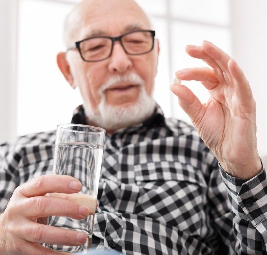 Man holding oral conscious dental sedation pill