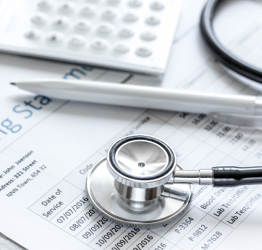 Medical billing statement with calculator and stethoscope