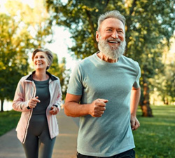 Healthy seniors jogging outdoors