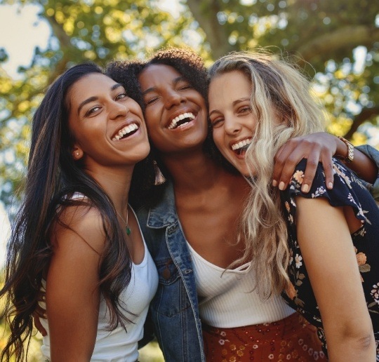 Three women with flawless smiles thanks to tooth colored fillings