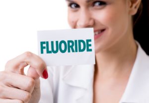 Woman holding a fluoride card