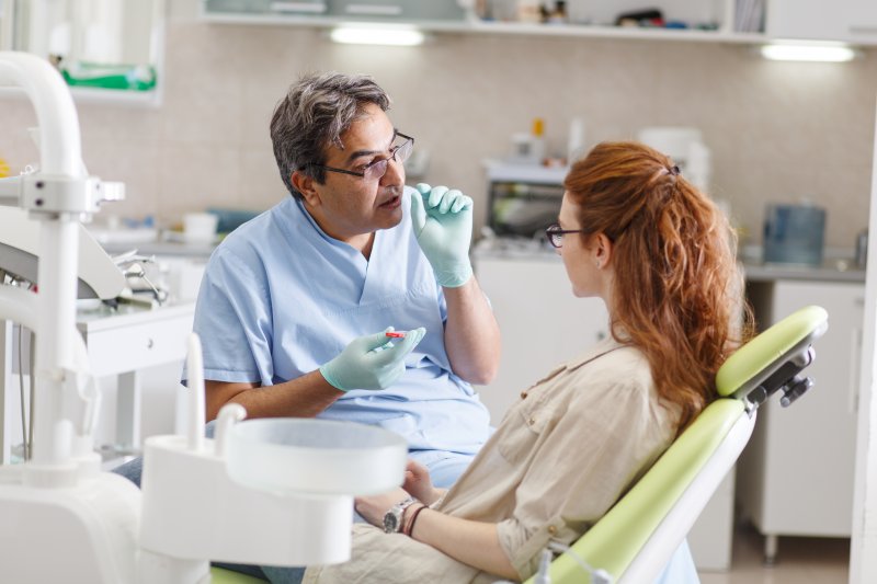 A dentist telling his patient about full mouth reconstruction work